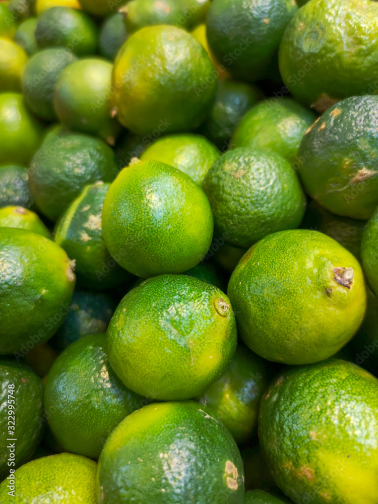 Green limes on the market as a background Green limes on the market as a background