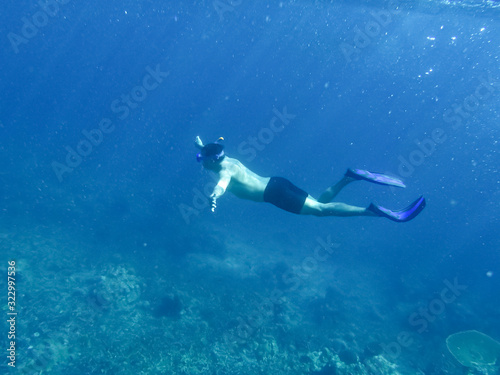 Underwater shoot in a sea and snorkeler on a surface 