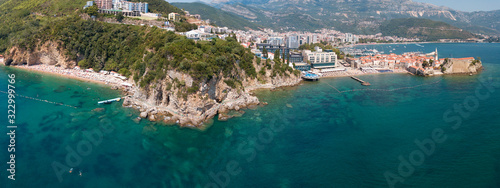 Aerial view of Mogren beach (two sandy beaches) and the old city (stari grad) of Budva. Montenegro. Jagged coast on the Adriatic Sea