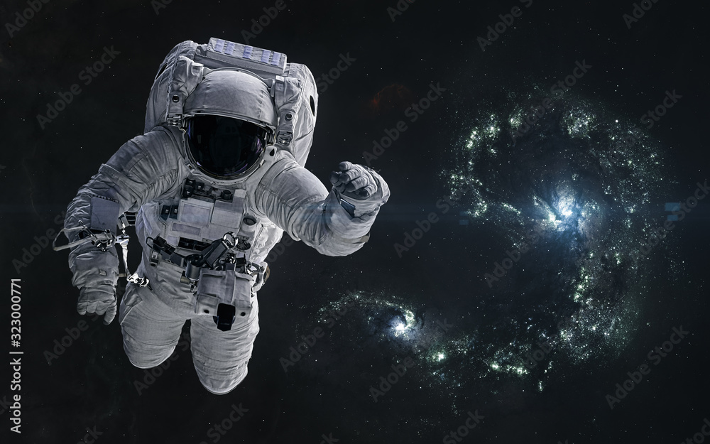 Astronaut on a background of colliding blue galaxies. Science fiction. Elements of this image furnished by NASA Astronaut on a background of colliding blue galaxies. Science fiction. Elements of this image furnished by NASA