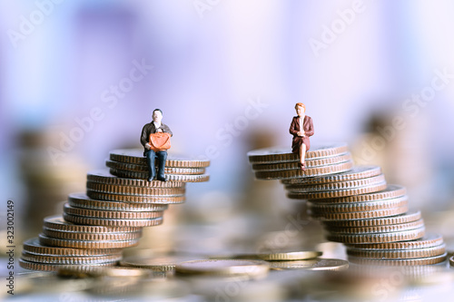 Miniature people: Elderly people sitting on coins stack. social security income and pensions. Money saving and Investment. Time counting down for retirement concept.