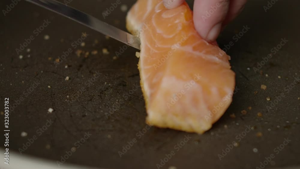 Salmon frying in pan - Slow Motion