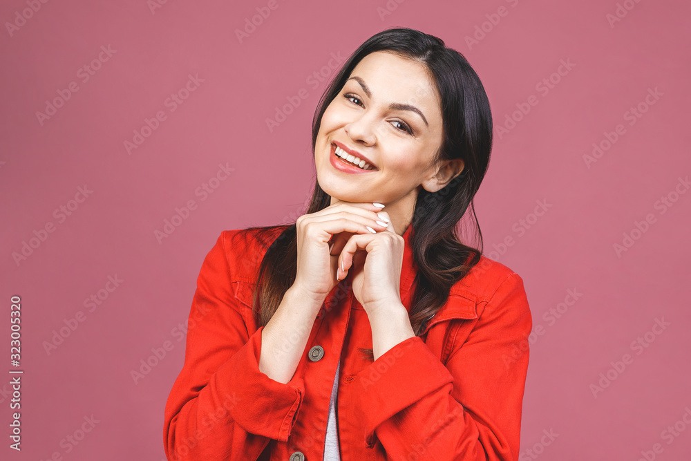 Photo of cheerful beautiful young woman standing isolated over pink wall background. Looking camera showing winner gesture. Photo of cheerful beautiful young woman standing isolated over pink wall background. Looking camera showing winner gesture.