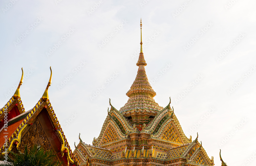 Fototapeta premium Ratchaworamahawihan (Wat Pho)in the evening sky is a beautiful ancient temple it is where both domestic and international tourists are popular in Bangkok Thailand ‎January ‎29, ‎2020