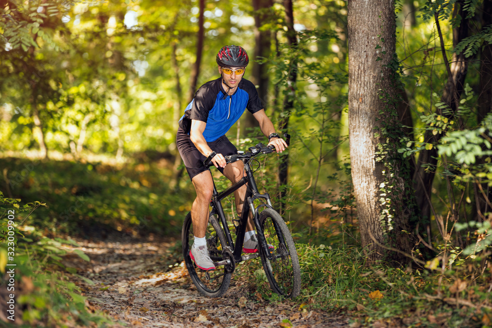 sporty man practicing mountain biking.Spring, nature ,sport concept