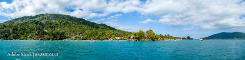View of coastline on Nosy Komba Island lined with palm trees and , Madagascar close to Nosy Be © Tobias
