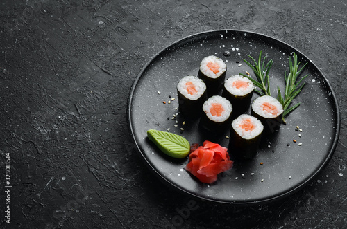 Sushi maki with salmon. Pieces of delicious sushi. Japanese cuisine