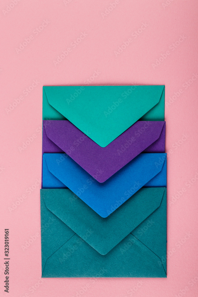 Colorful envelopes on a pink background.
