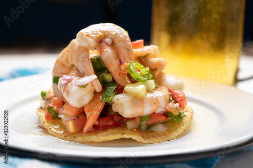 Mexican shrimp ceviche toast also called tostada on black background photo