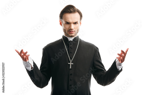 confident, serious catholic priest standing with open arms isolated on white photo