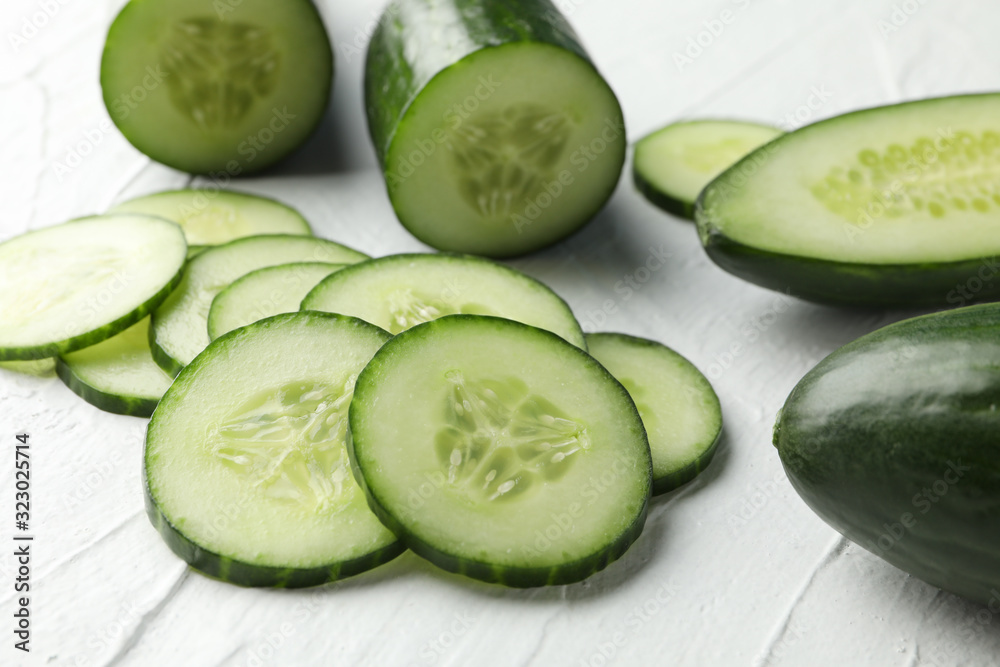 Cucumbers and slices on white background, close up Cucumbers and slices on white background, close up