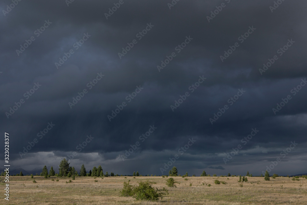 Highway 8 near Twizel.  Lake Ruataniwha. Ben Ohau. New Zealand Prairie and dark thunderclouds