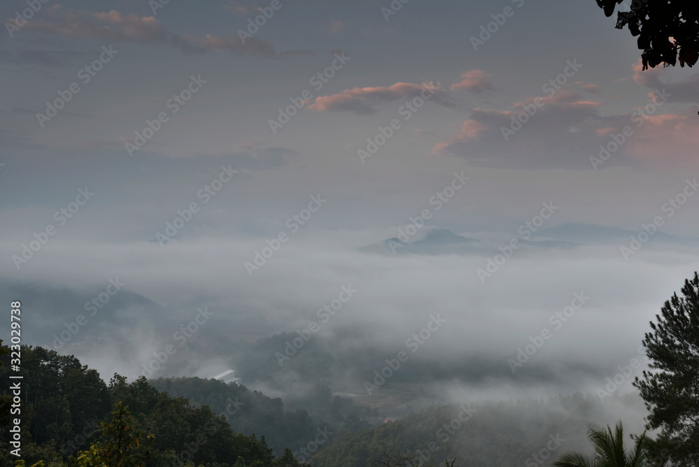 Beautiful sea of fog in a valley with orange sky cloud in a sunrise time Beautiful sea of fog in a valley with orange sky cloud in a sunrise time