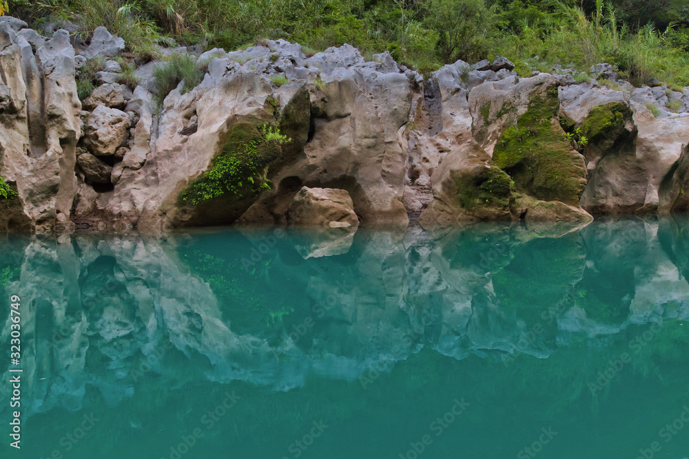 Fototapeta premium Amazing crystalline blue water of Tamul waterfall, Close up view of spectacular Tamul River,at Huasteca Potosina in San Luis Potosi, Mexico