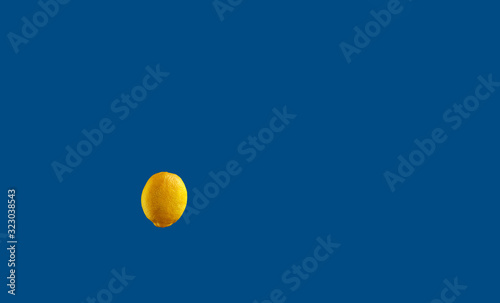 Yellow lemon on a background of blue classic color.