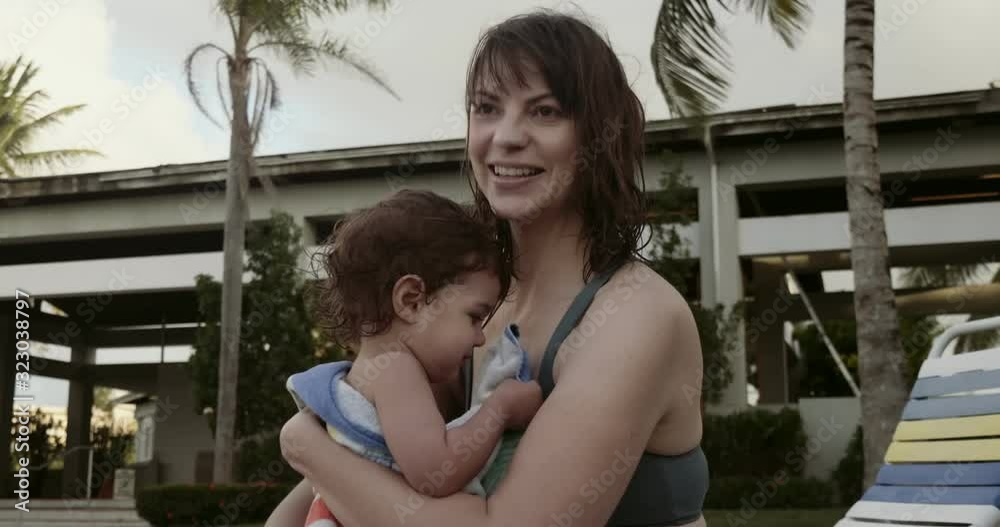 Mother and baby girl enjoying vacation poolside. Mother and baby girl enjoying vacation poolside.