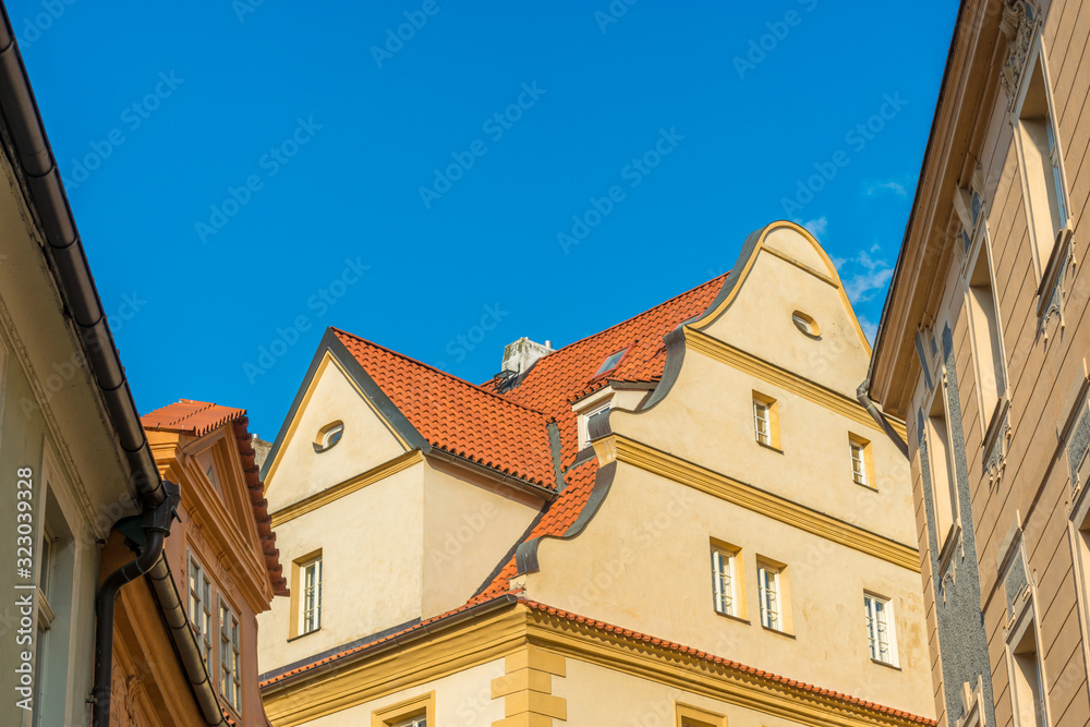 View of the top of old buildings with red roof and blue sky at Prague city Czech republic.