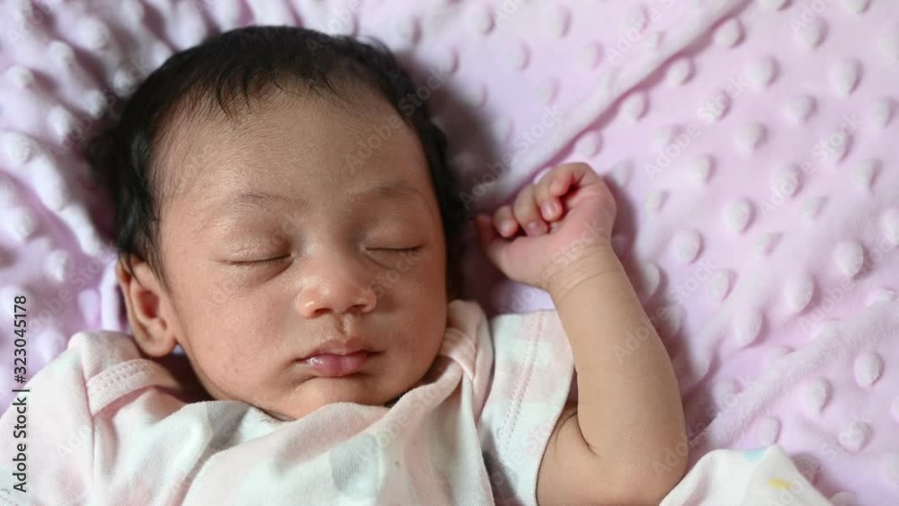 4K Close up new born asian baby sleep or nap on the pink blanket. Happy family and baby concept background. 4K Close up new born asian baby sleep or nap on the pink blanket. Happy family and baby concept background.