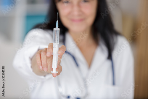 female doctor is injecting someone
