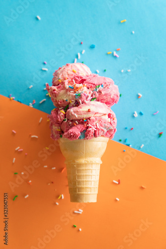ice cream on a cone in front of blue and orange background
