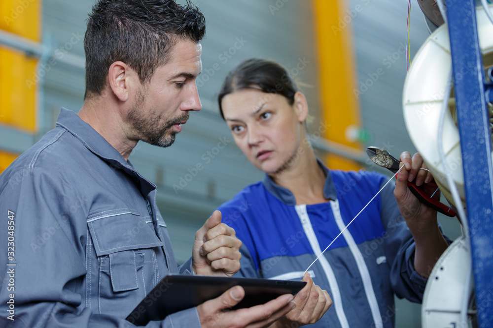man mechanic and woman discussing an issue man mechanic and woman discussing an issue