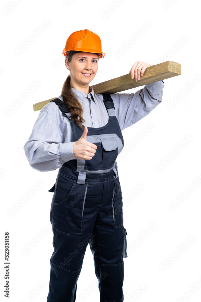 Girl builder with a wooden board in her hands shows likes. isolated Girl builder with a wooden board in her hands shows likes. isolated