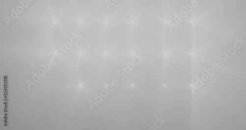 Spotlights sequentially begin to shine brightly and go out.