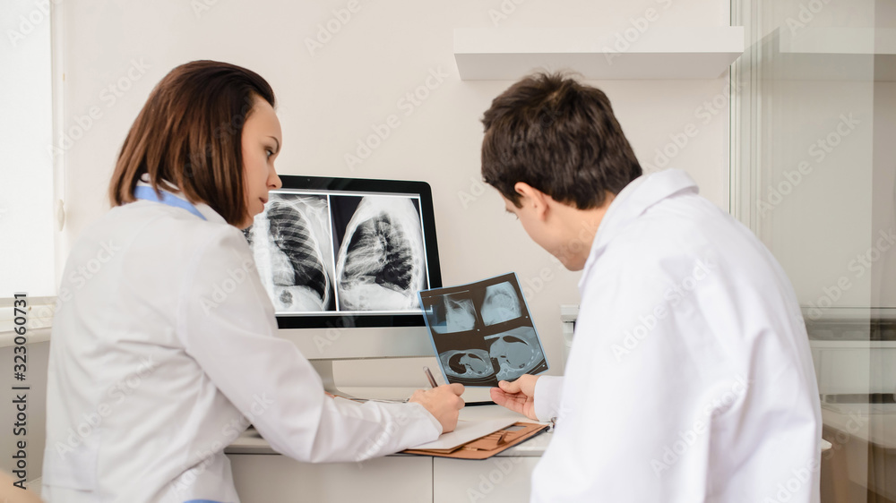 Back view of young doctors radiologists analises x-ray