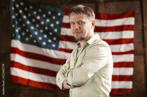 Patriotic American Businessman Amid On American Flag Blurred Back