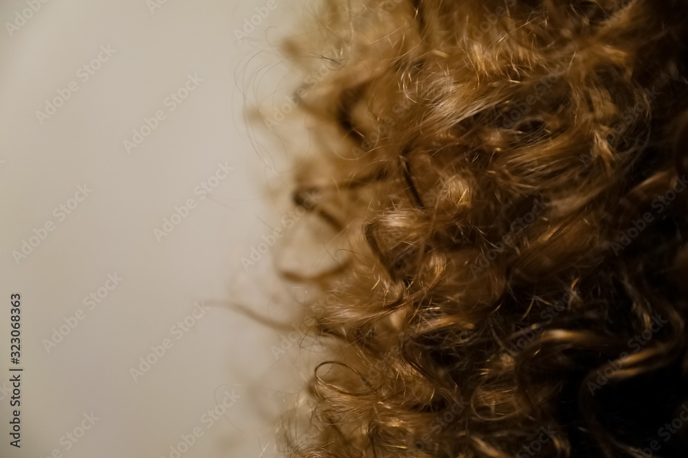 Obraz premium Natural blonde curly hair. Hair background.