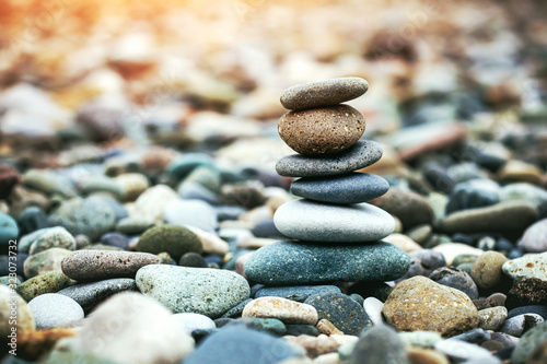 Sea pebble stones tower on beach. Balance and harmony concept