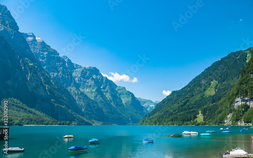 Stunning panorama view of Kloental lake (Kloenthalsee) and Bruennelistock (Brunnelistock) and Swiss Alps on a sunny summer day with blue sky cloud in background, Canton of Glarus, Switzerland © Peter Stein