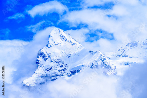 The Swiss Alps at Murren, Switzerland. Jungfrau Region. Tops of the mountains in fog and clouds. © karamysh