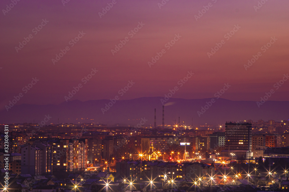 Red sunset sky over the city and mountains silhouette Red sunset sky over the city and mountains silhouette