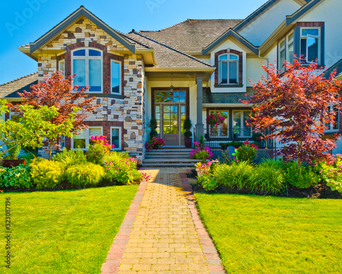 Entrance of a house with nice outdoor landscape over blue sky