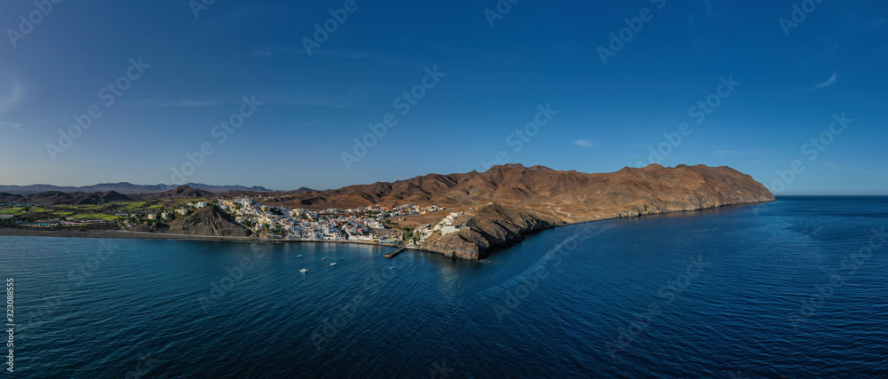 Obraz premium Fuerteventura holidays - scenic coastal village Gran Tarajal, Canary islands. Aerial drone view in october 2019