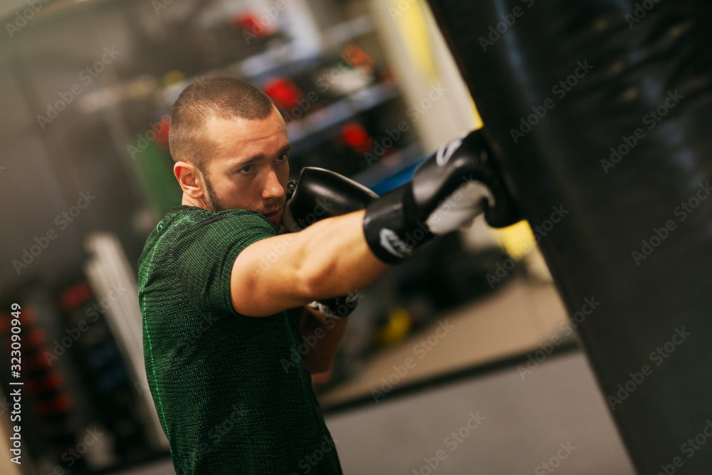 Image of fit strong sports man boxer make exercises in gym Image of fit strong sports man boxer make exercises in gym
