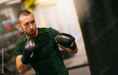 Image of fit strong sports man boxer make exercises in gym © Etoilestars