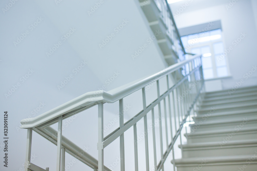 Fototapeta premium A white stairs up ladder in a new office building