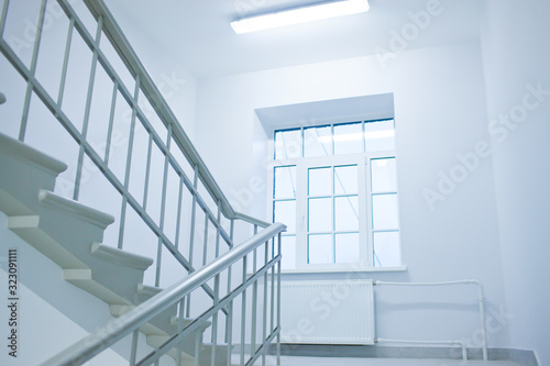 A white stairs up ladder in a new office building