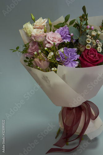 Romantic bridal or congratulatory bouquet, light gray background, selective focus photo