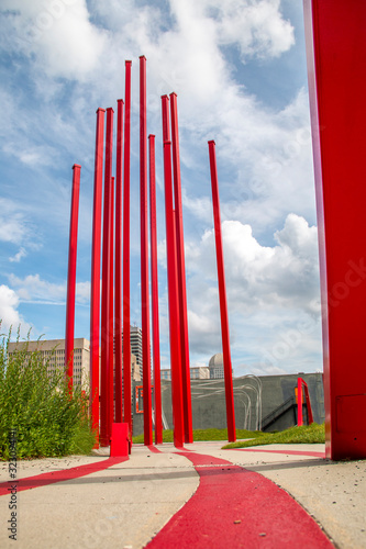 Red poles pointing toward a cloudy sky