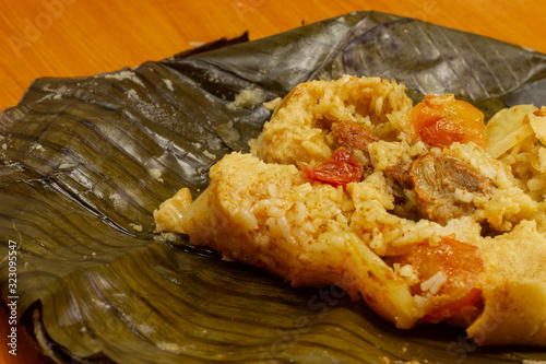 Nacatamal typical Nicaraguan food, corn, meat, butter, potatoes, onion, wrapped banana leaf