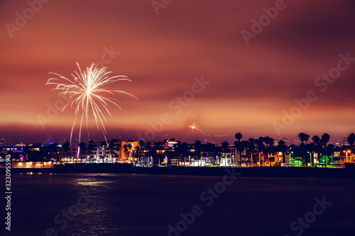 Distant view of Santa Monica during celebration with fireworks at night 