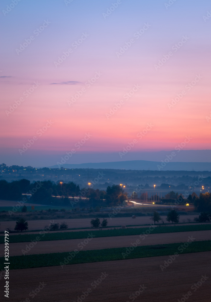Countryside and farmland interrupted by a road after sunset (long exposure) Countryside and farmland interrupted by a road after sunset (long exposure)