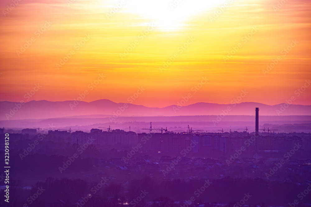 Beautiful sunset sky over the evening city