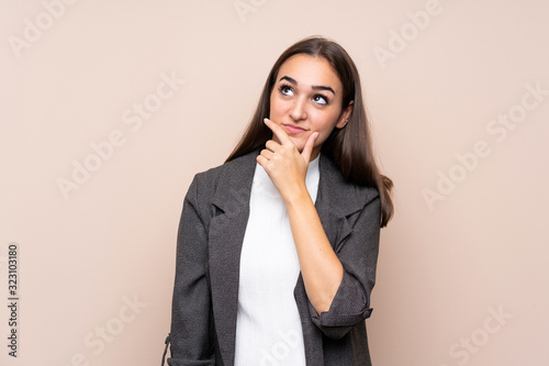 Young girl over isolated background thinking an idea