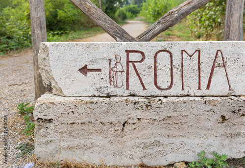 Via Francigena (pilgrim's route to Rome) way marker showing the direction to Rome photo