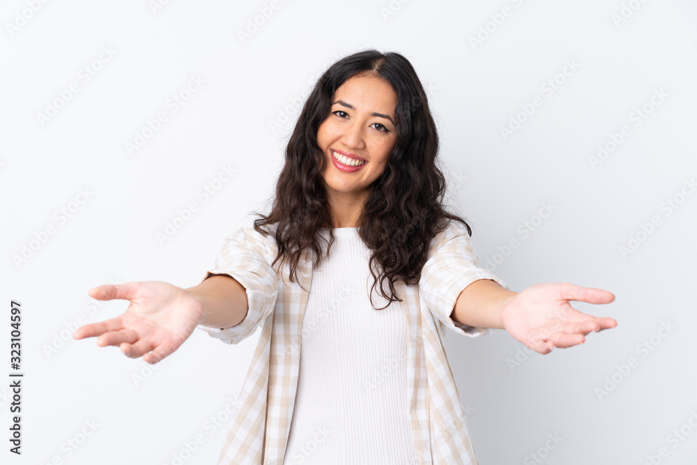 Mixed race woman over isolated white background presenting and inviting to come with hand Mixed race woman over isolated white background presenting and inviting to come with hand