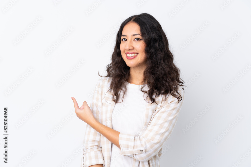 Mixed race woman over isolated white background pointing back Mixed race woman over isolated white background pointing back